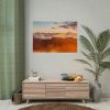 Clouds Envelope a Mountain Range During Sunset Poster