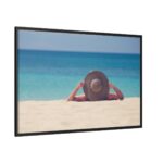 Woman Wearing a Hat on the Beach Framed Canvas