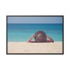Woman Wearing a Hat on the Beach Framed Canvas